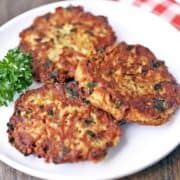 Tuna patties on a white plate garnished with parsley.