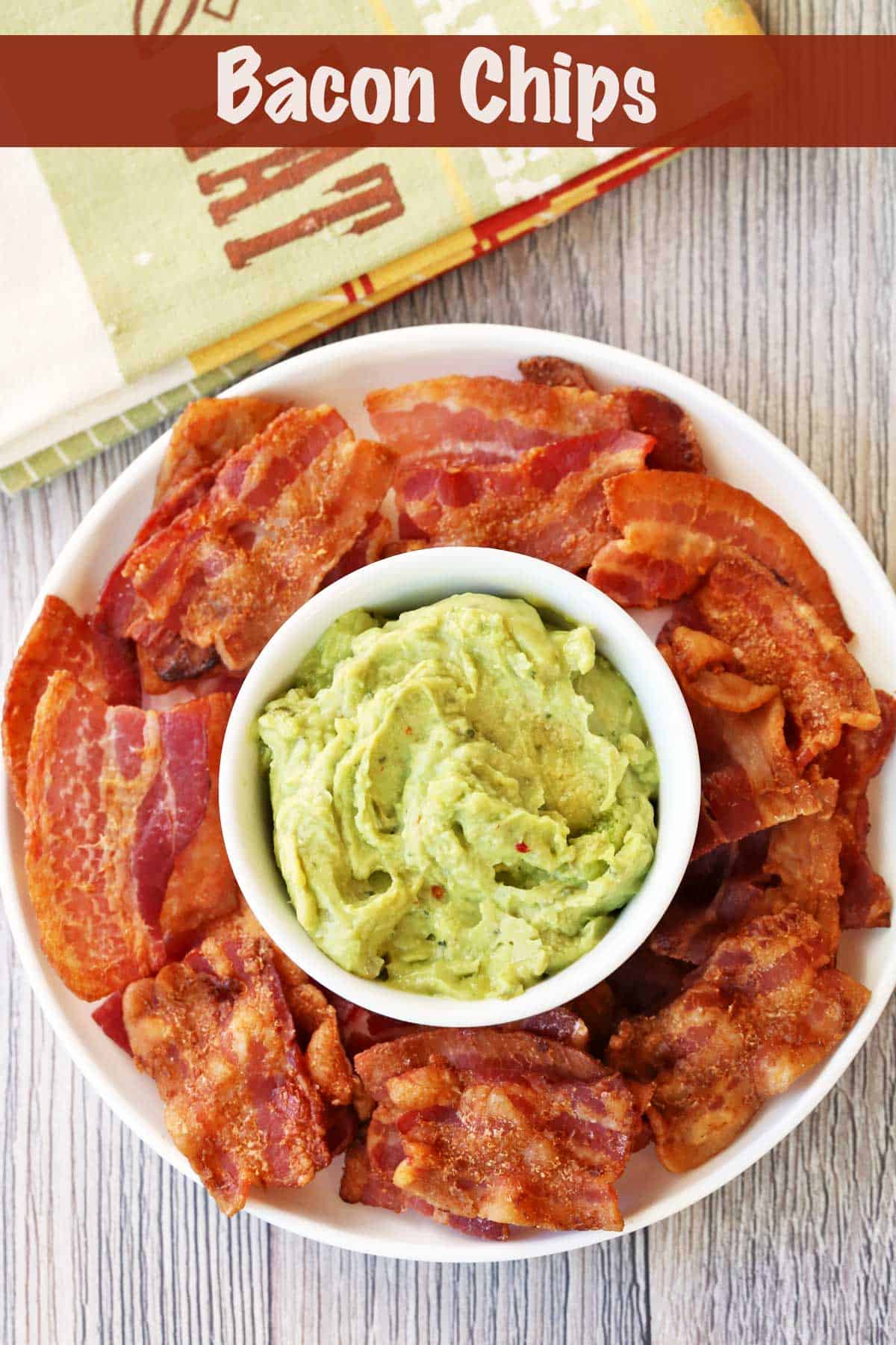 Bacon chips served on a plate with a bowl of guacamole.
