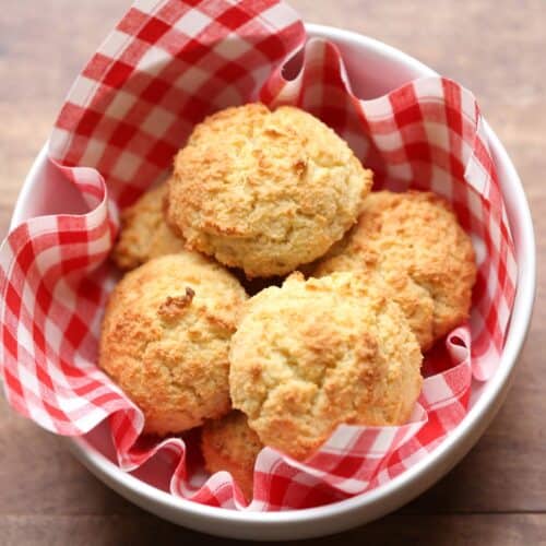 Keto biscuits are served in a white bowl lined with a napkin.