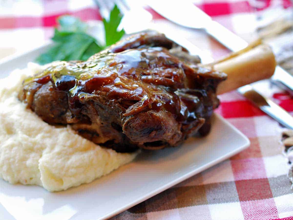 Lamb shank, cooked in the slow cooker, served on a bed of cauliflower mash. 