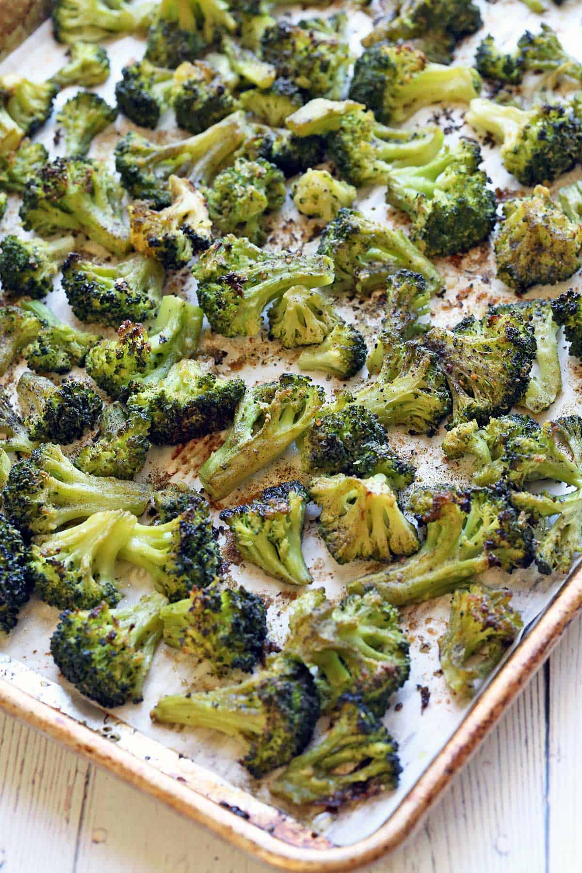 Roasted frozen broccoli on a baking sheet. 