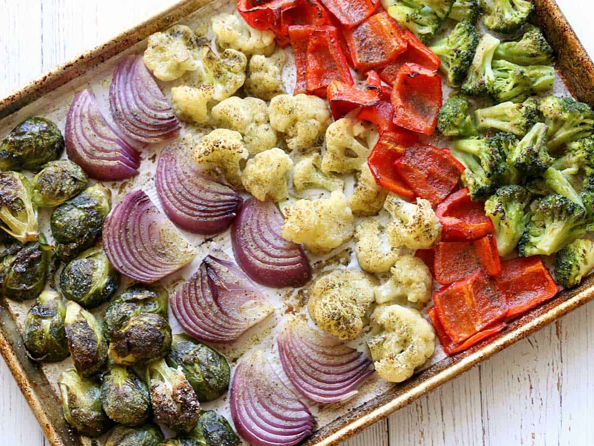 Oven-roasted vegetables arranged in a large baking sheet.