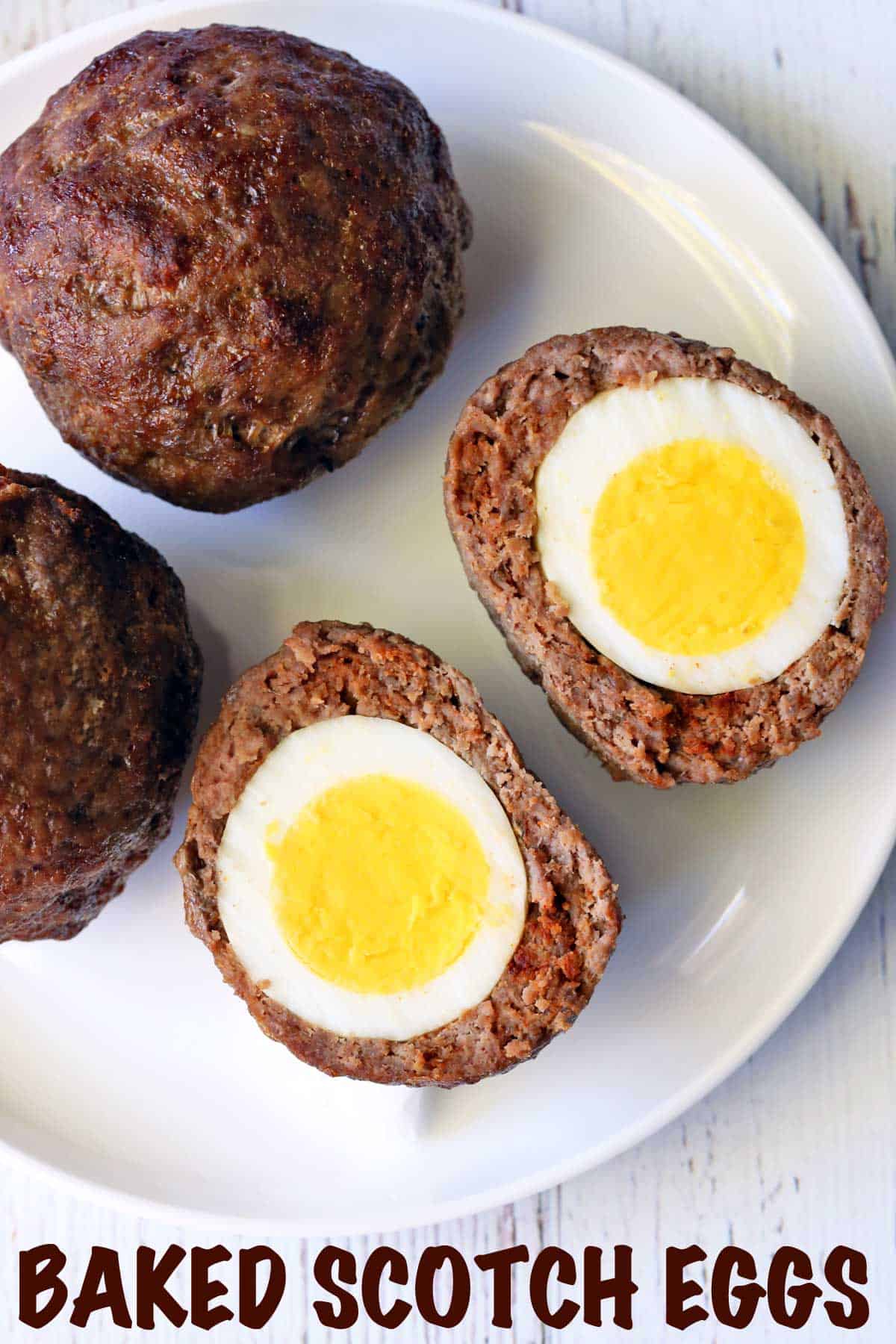 Oven-baked Scotch eggs served on a white plate.