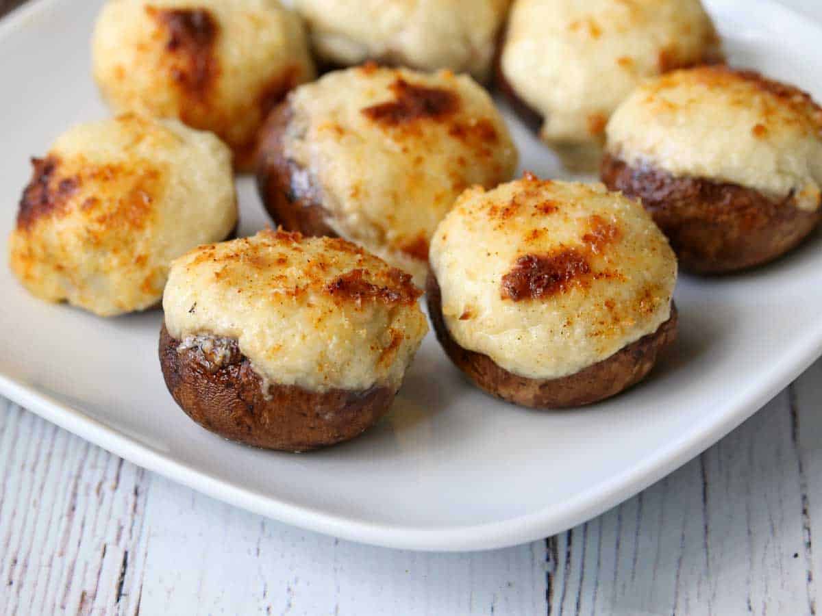 Stuffed mushrooms served on a white plate.