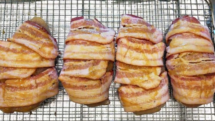 The bacon-wrapped chicken breasts are coated in a honey-mustard sauce.