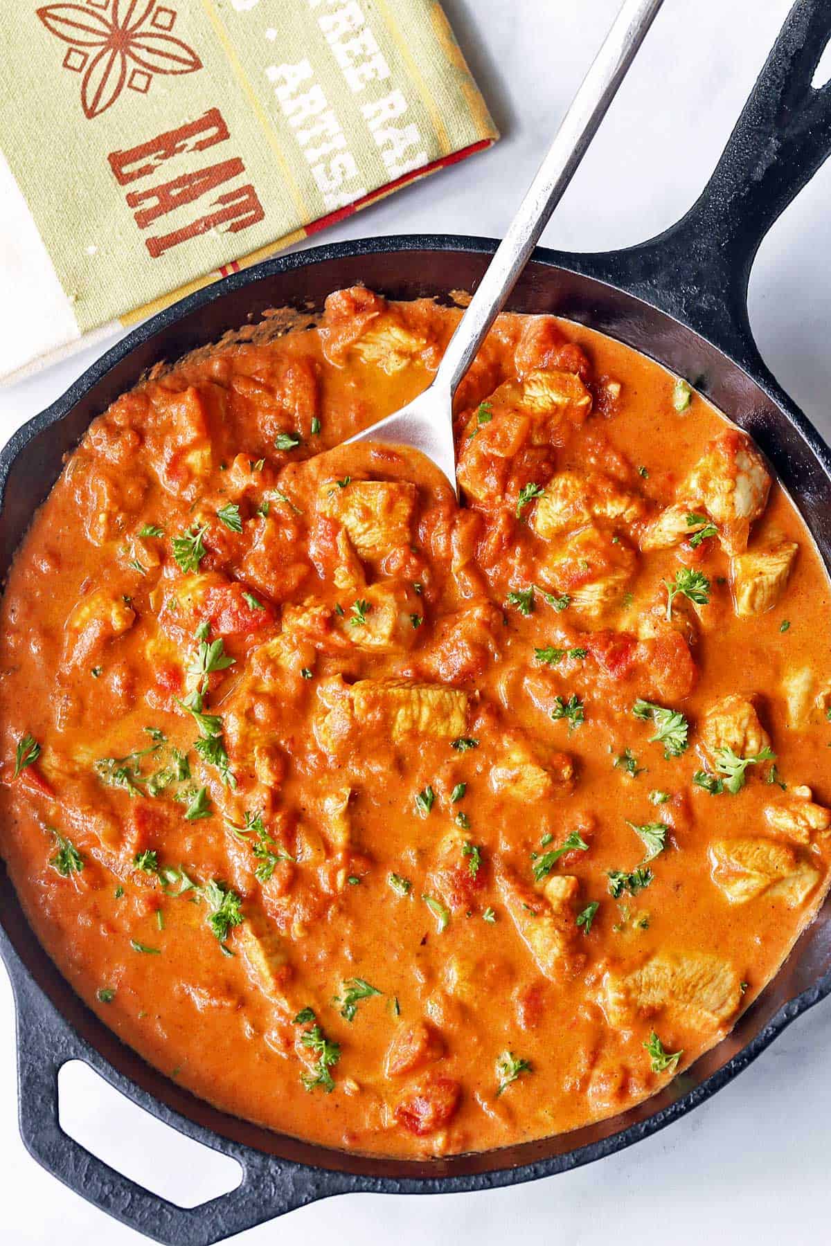 Butter chicken served in a cast-iron skillet. 