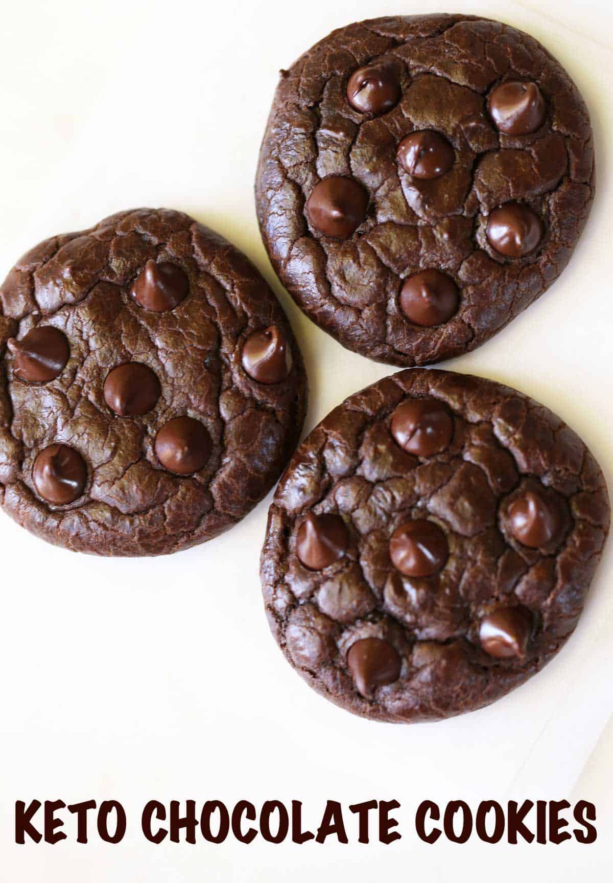 Three keto chocolate cookies on a white background. 