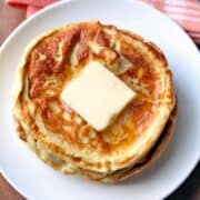 Cream cheese pancakes topped with butter.