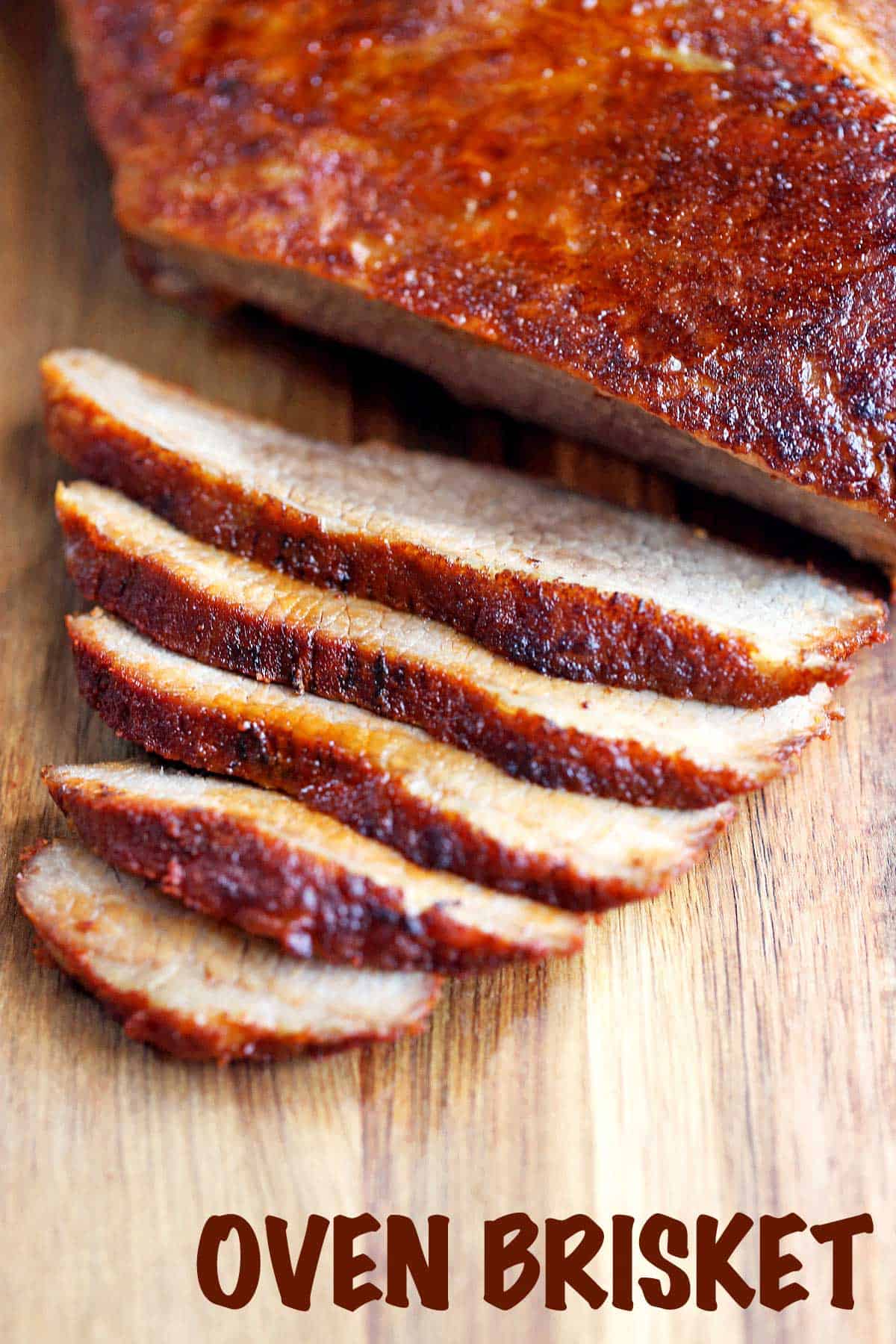 Oven-baked brisket, sliced, served on a wooden cutting board. 