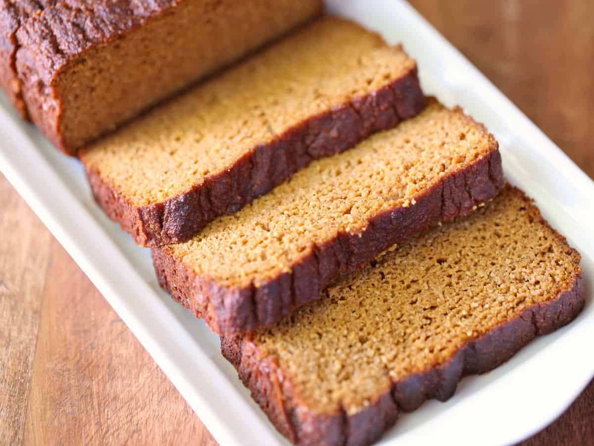 Sliced keto pumpkin bread on a white serving tray. 