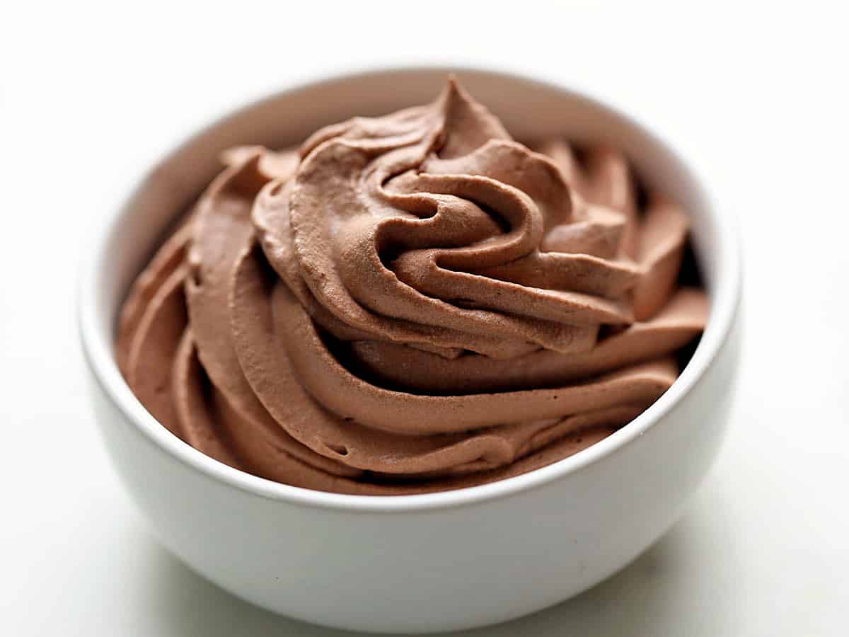 Keto chocolate whipped cream is served in a white bowl. 