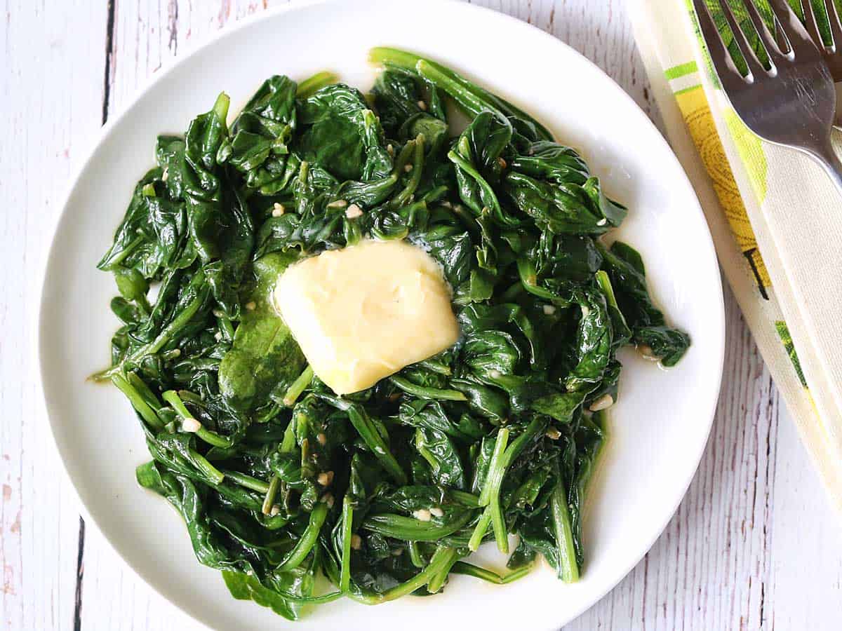 Sauteed spinach topped with butter. 