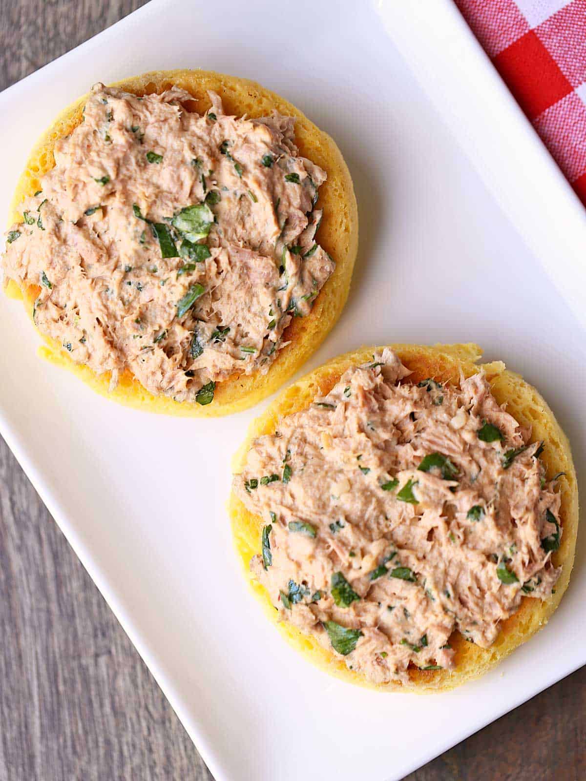 Keto tuna salad served on low-carb bread, on a white plate. 