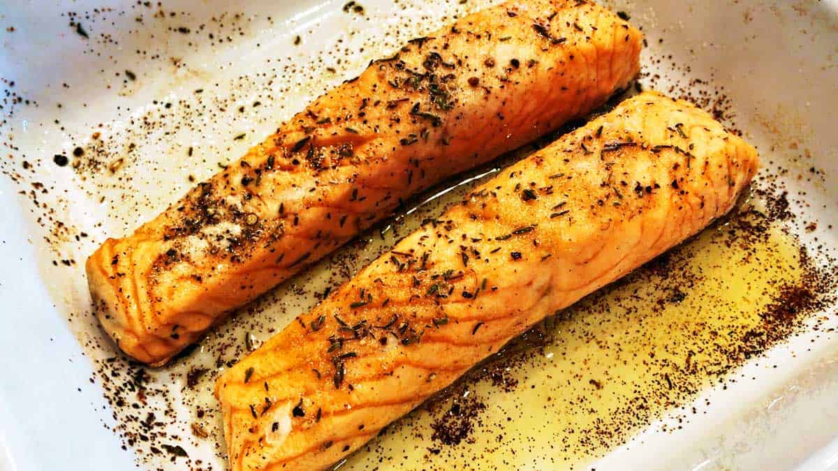 Cooked salmon fillets in a baking dish. 