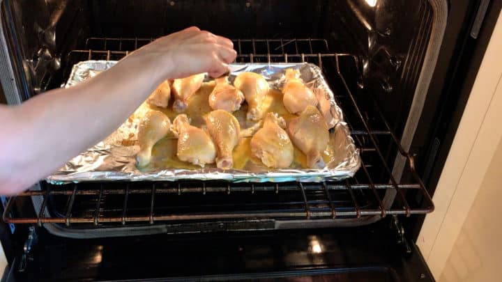 Basting the chicken during cooking.