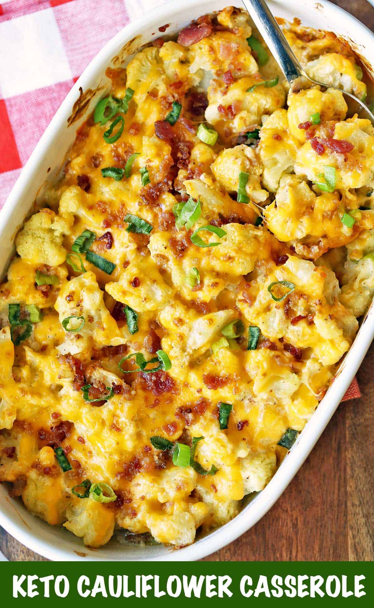Keto cauliflower casserole topped with cheese and bacon. 
