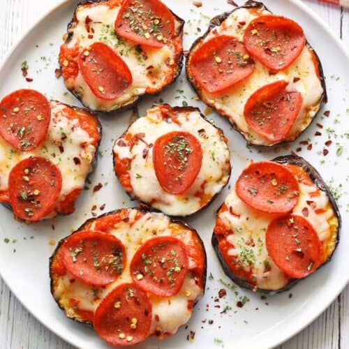 Eggplant pizza served on a white plate.