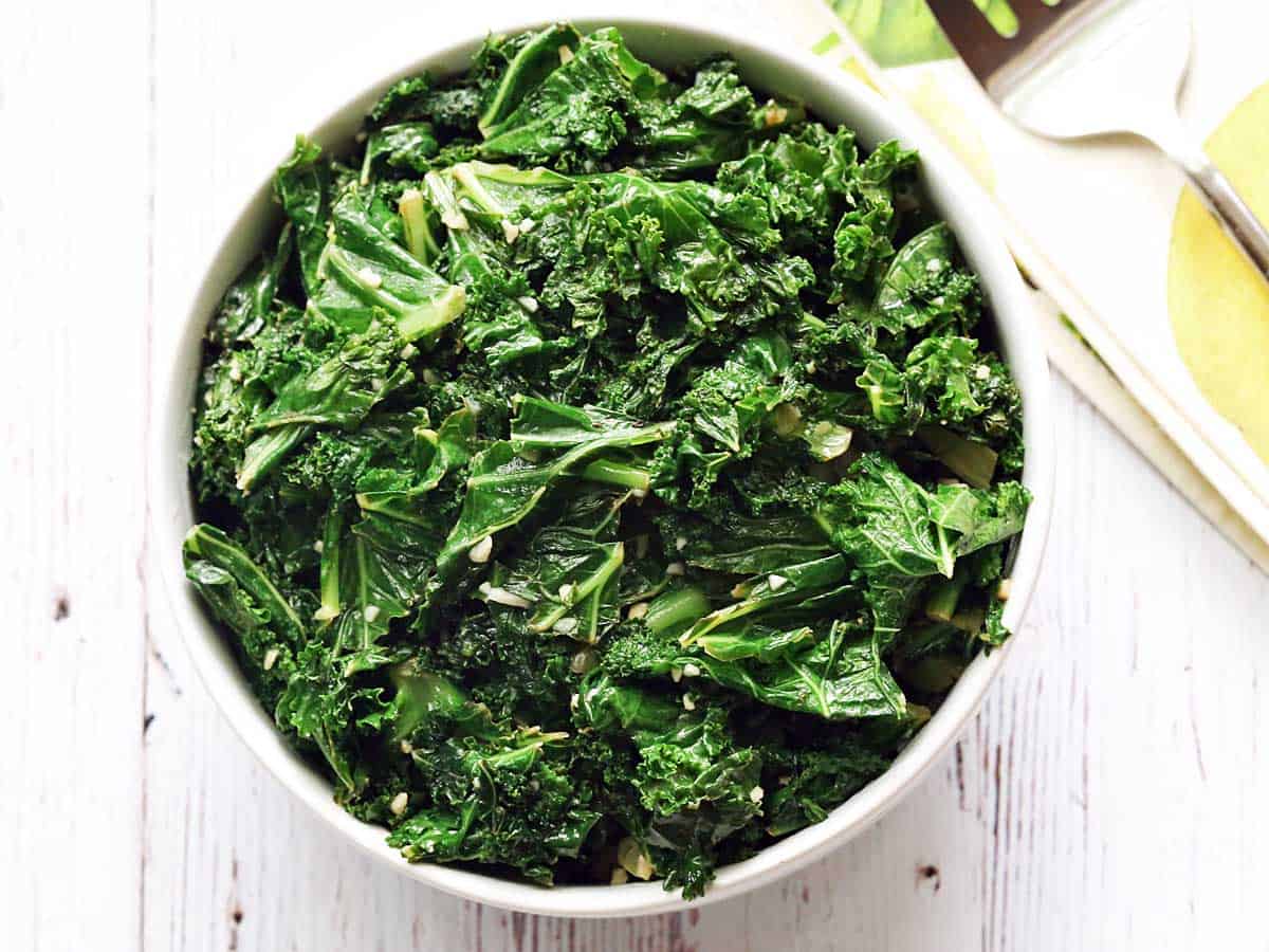 Sauteed kale served in a white bowl. 