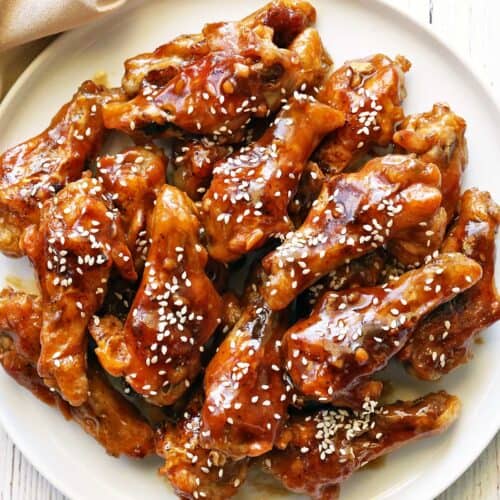 Teriyaki chicken wings topped with sesame seeds.