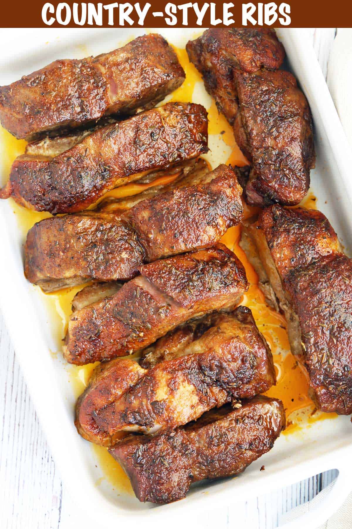 Country-style pork ribs served in a white baking dish. 