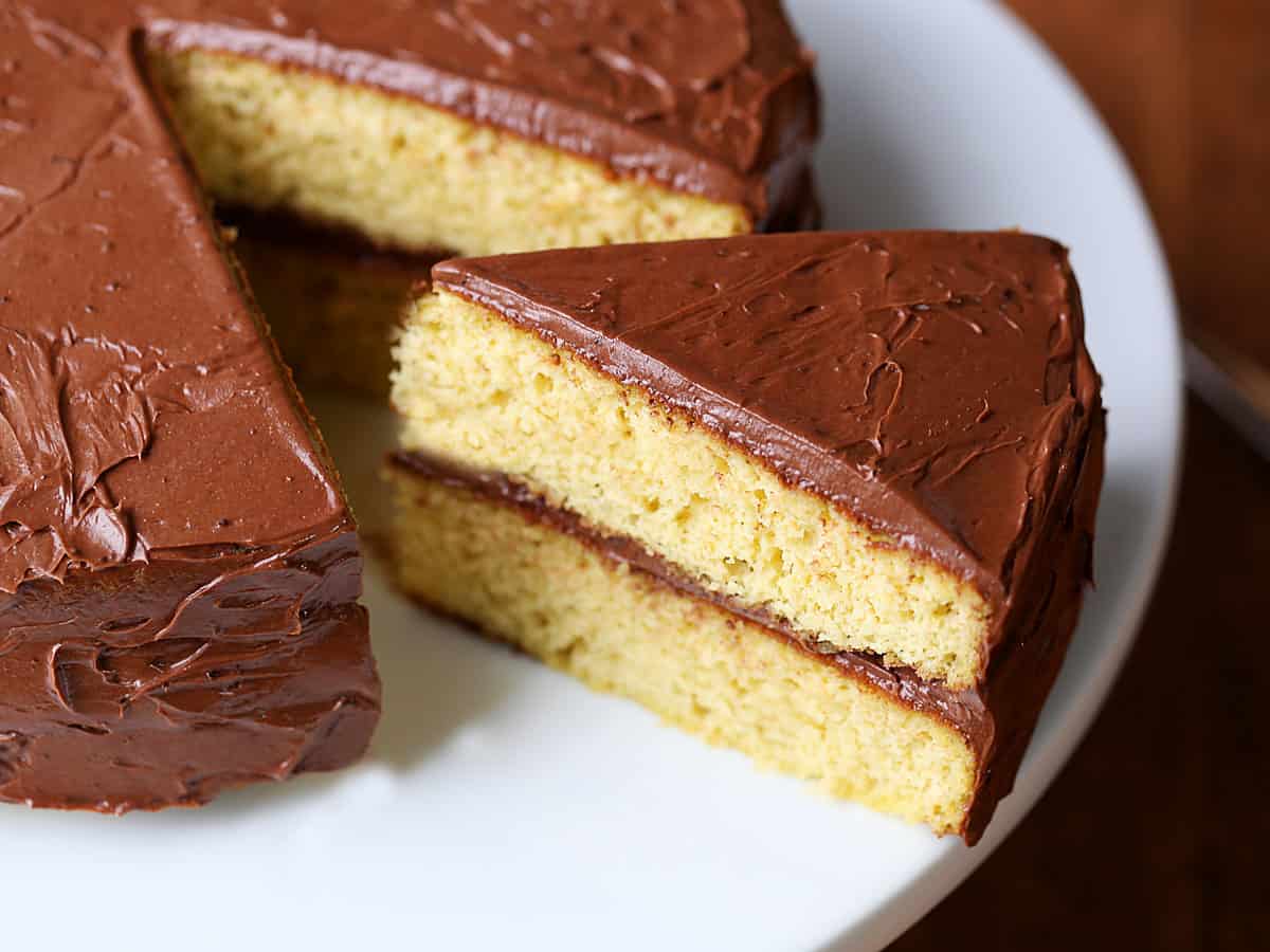 A slice of keto birthday cake with chocolate frosting. 