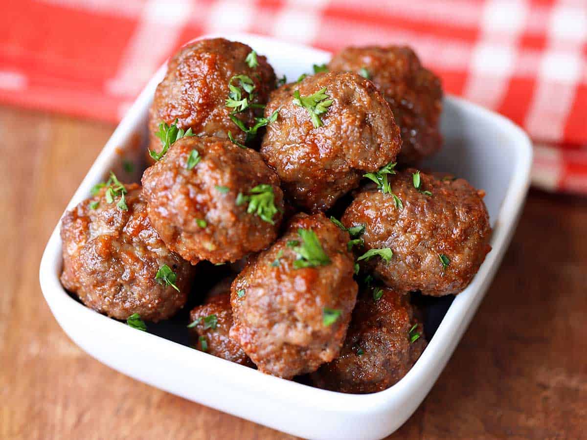 Meatballs without breadcrumbs served in a white bowl.