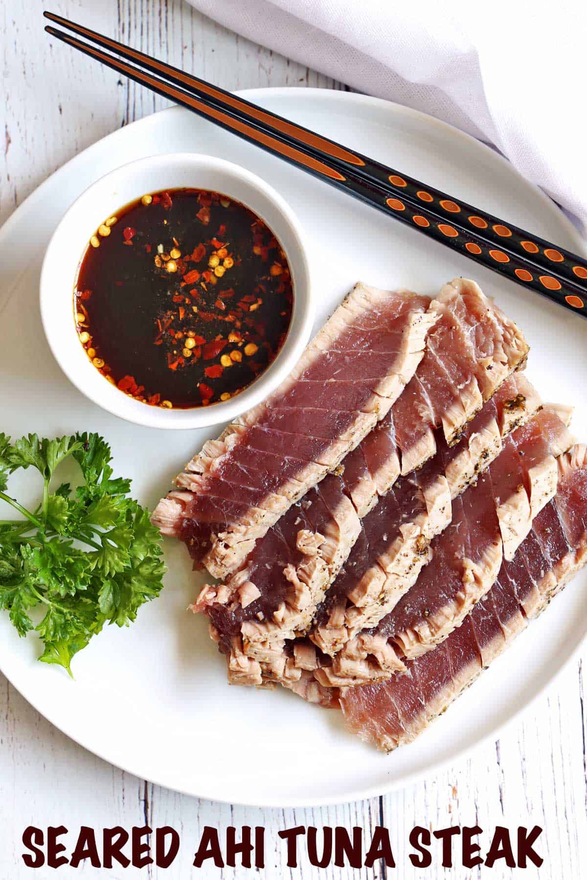 Seared ahi tuna steak served with a dipping sauce. 