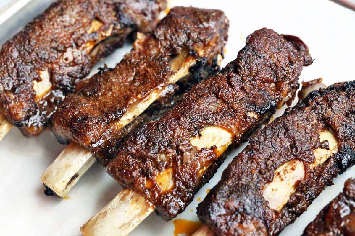 Slow cooker beef ribs served on a baking sheet. 