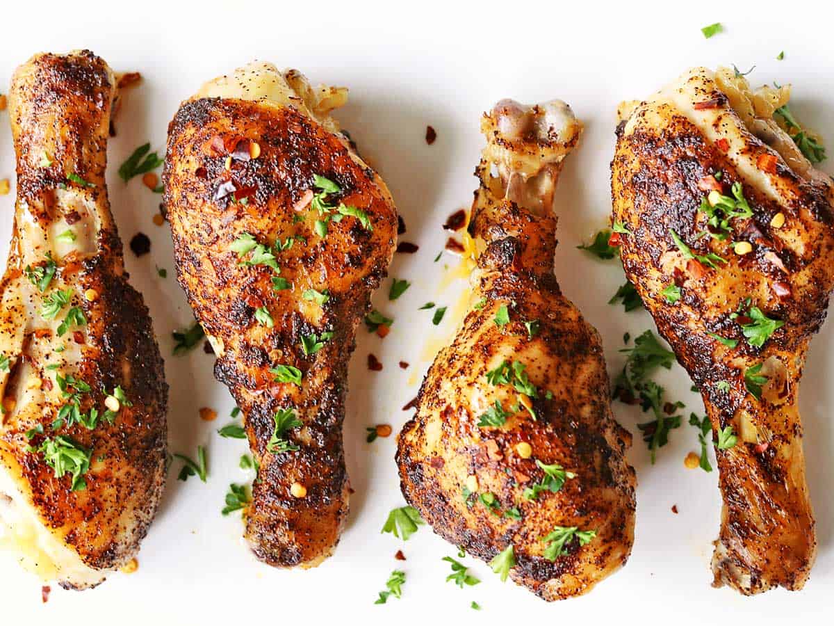 Spicy chicken drumsticks photographed on a white background. 