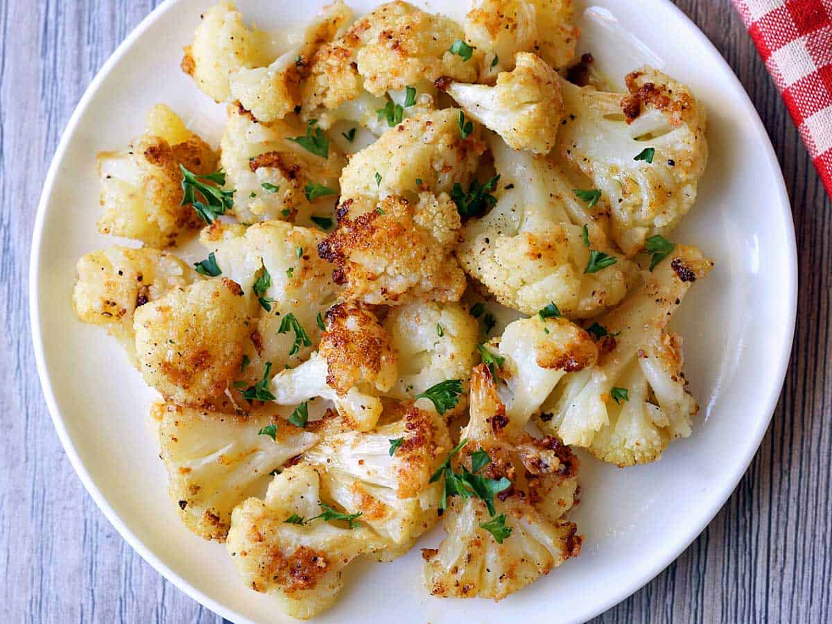 Oven-roasted cauliflower served on a white plate. 