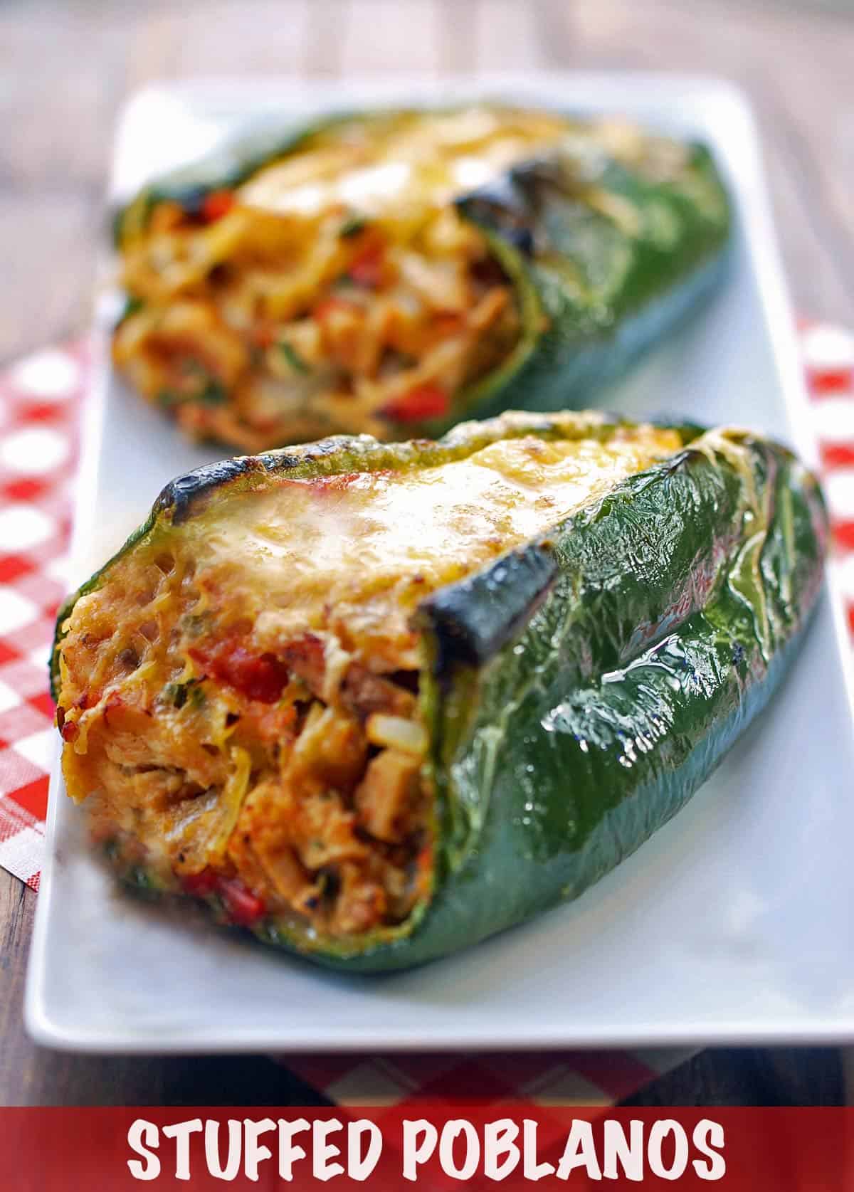 Stuffed poblanos served on a white plate with a napkin.