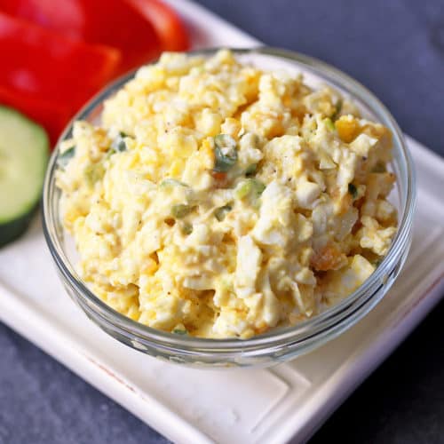 Keto egg salad served in a bowl with fresh-cut vegetables.