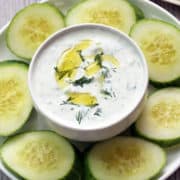 Tzatziki sauce served with cucumber slices.