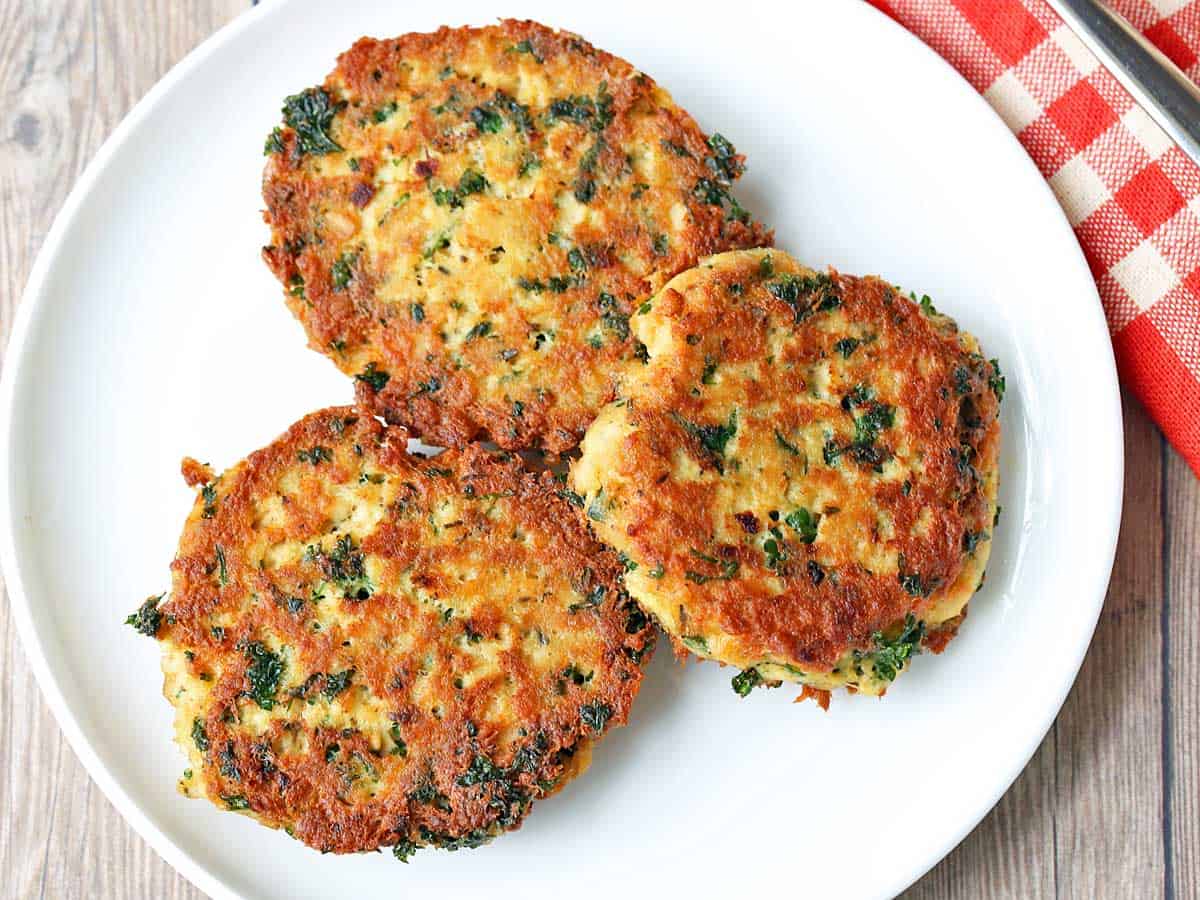 Salmon cakes served on a white plate. 