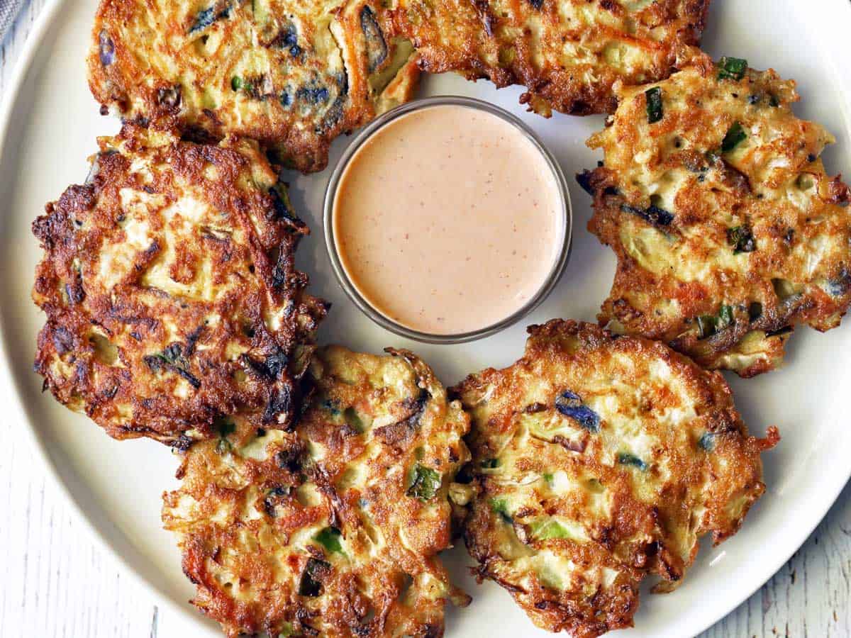 Cabbage pancakes served with a dipping sauce. 