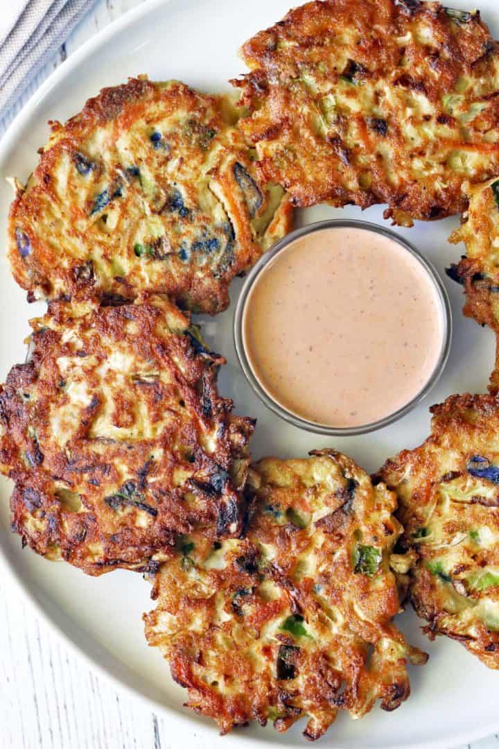 Cabbage pancakes served with a dipping sauce. 