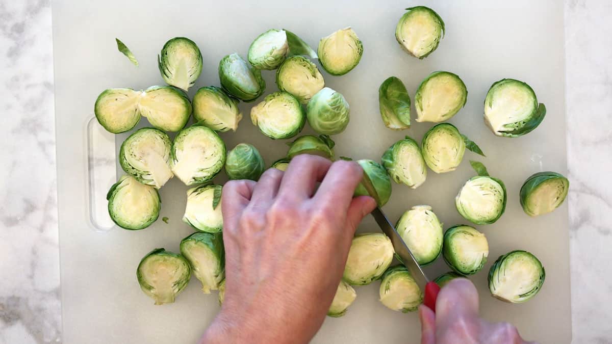 Cutting Brussels sprouts in half. 