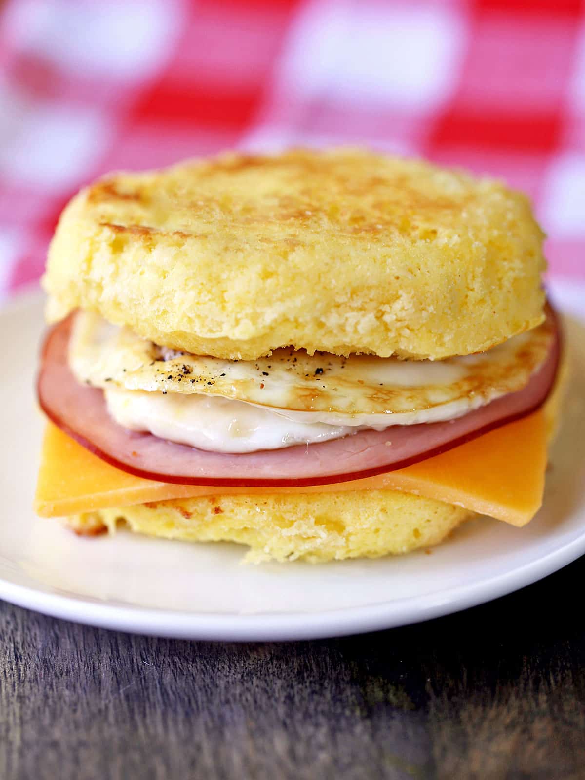 Keto breakfast sandwich served with a checkered red and white napkin. 