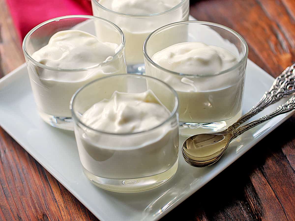 Ricotta dessert served in small glass cups with spoons. 