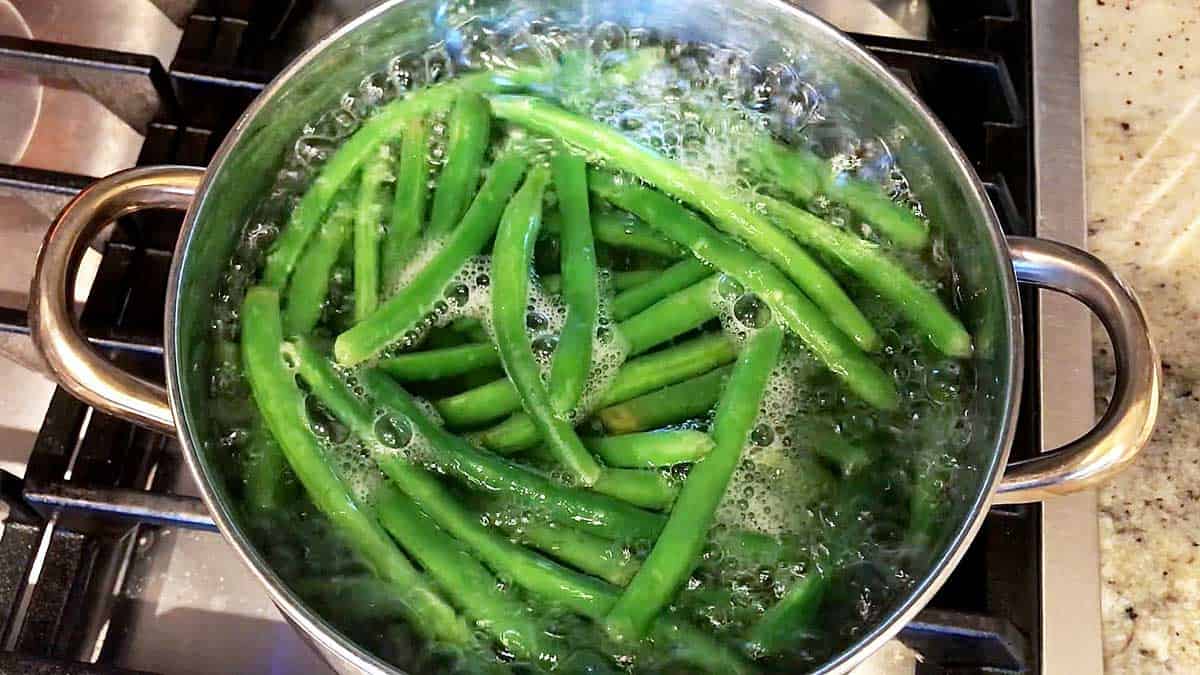 Green beans in a pot of boiling water. 