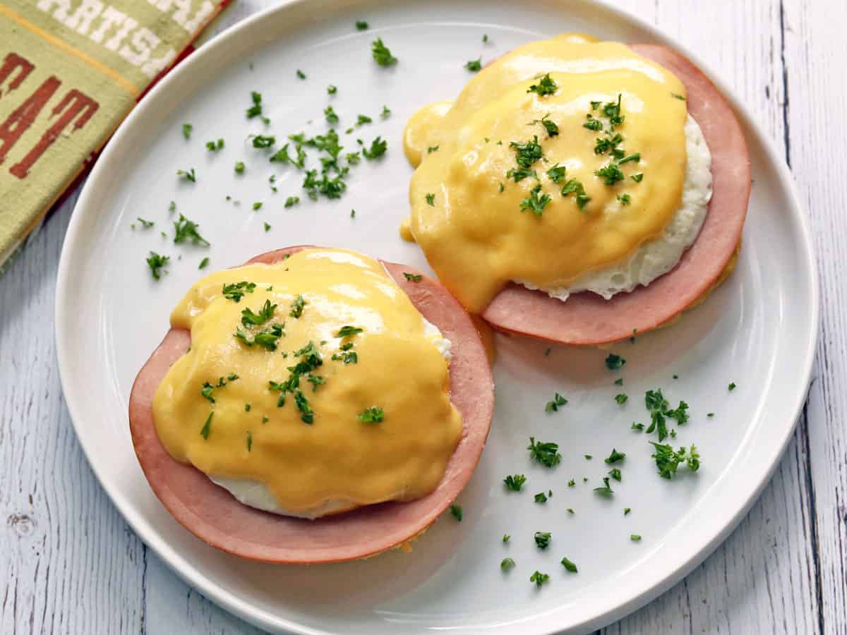 Keto eggs benedict served on a white plate. 