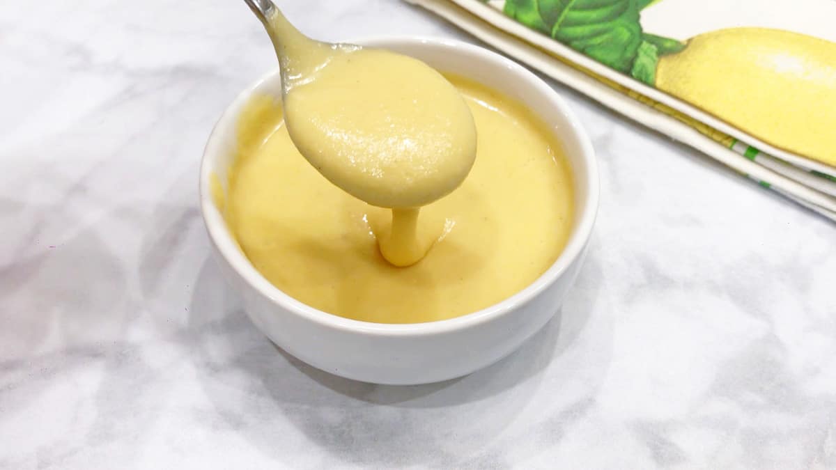Blender hollandaise sauce served with a spoon. 