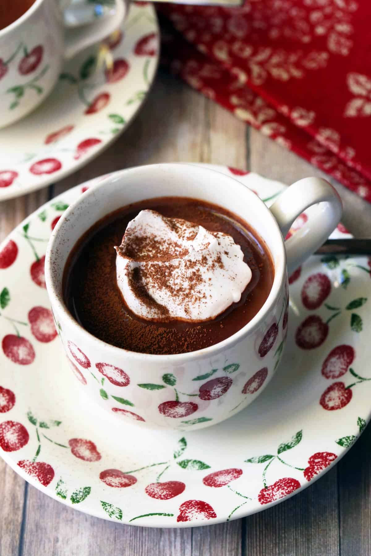 Keto hot chocolate served in a mug and topped with whipped cream. 