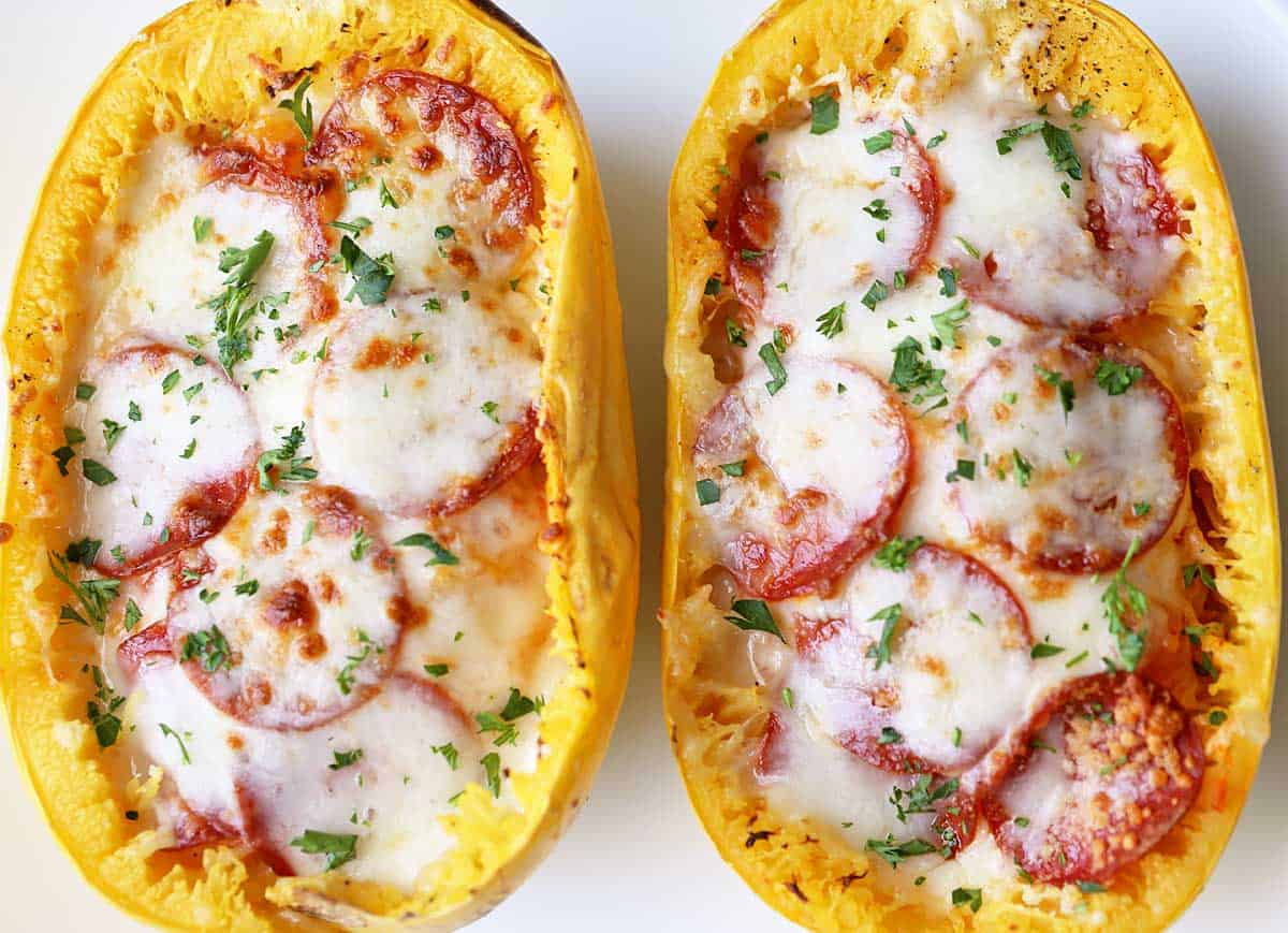 Two spaghetti squash boats served on a white plate. 