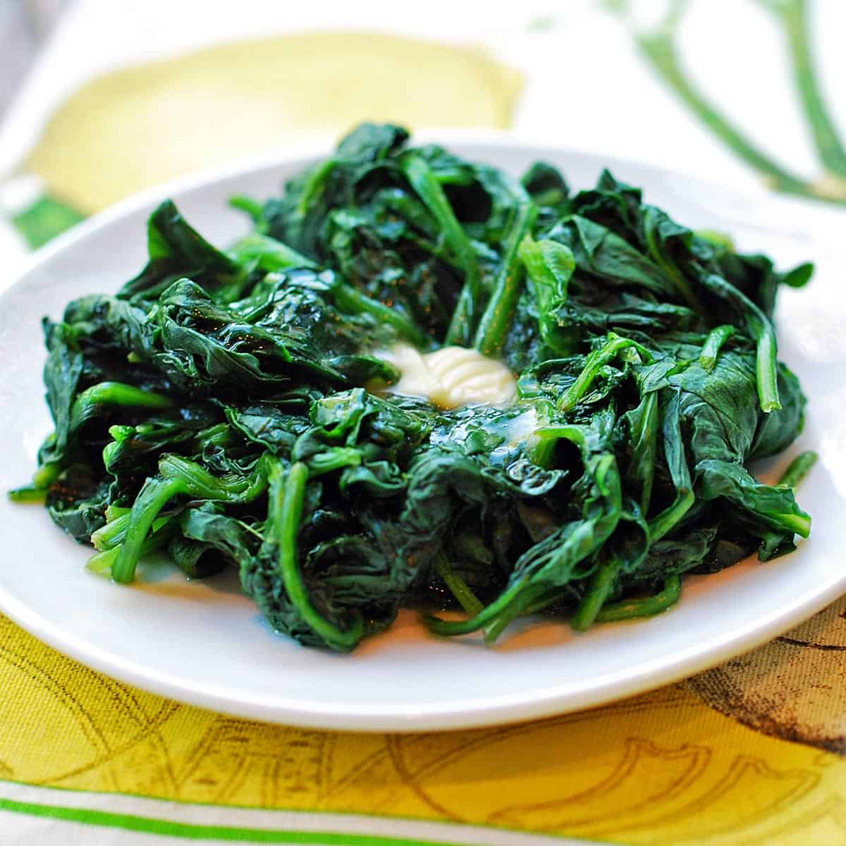 Steamed spinach topped with a pat of butter. 