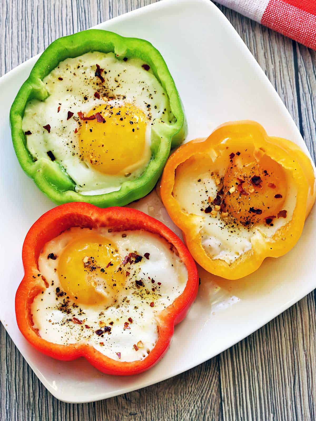 Three bell pepper eggs served on a white plate.