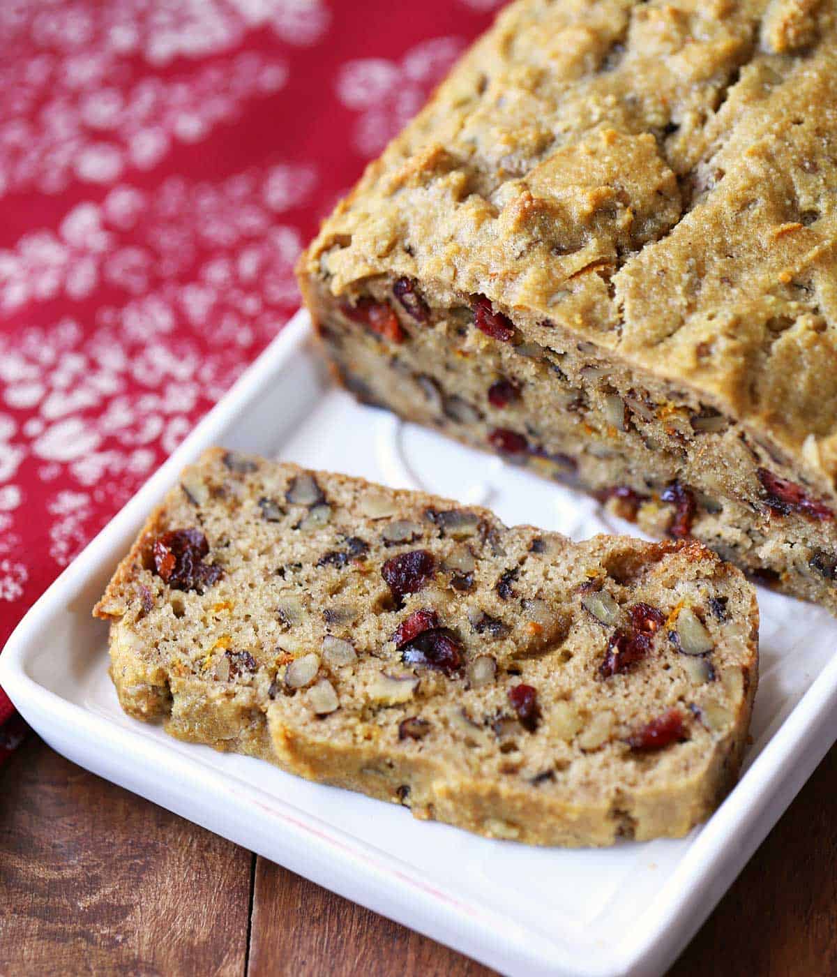 Low-carb fruitcake, sliced and served on a white tray. 