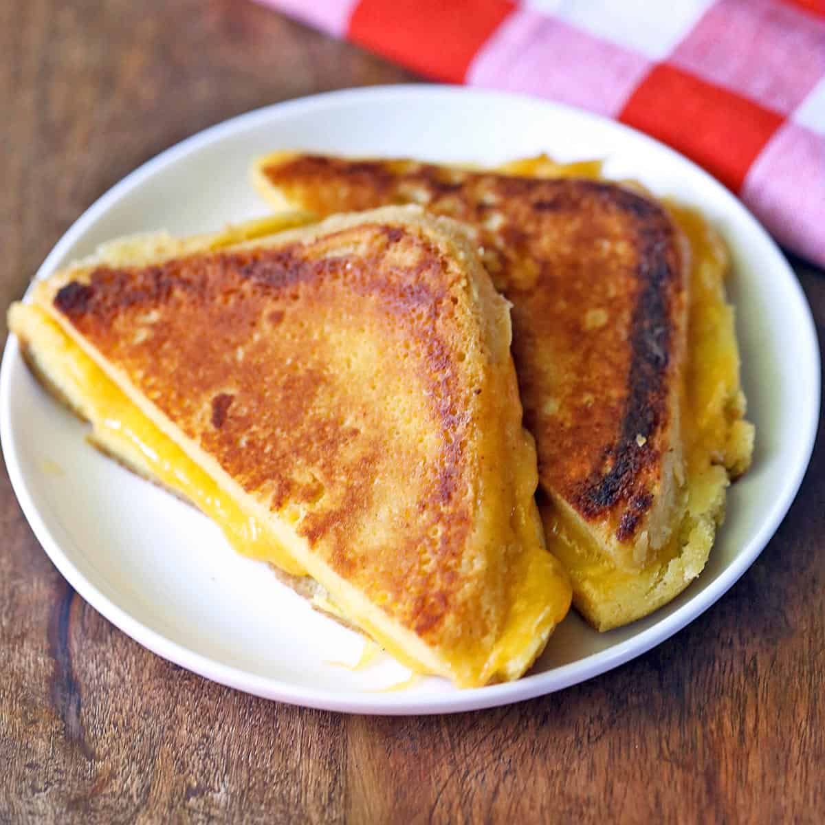 Keto grilled cheese sandwich served on a white plate. 