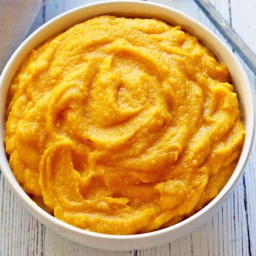 Mashed pumpkin served in a white bowl.