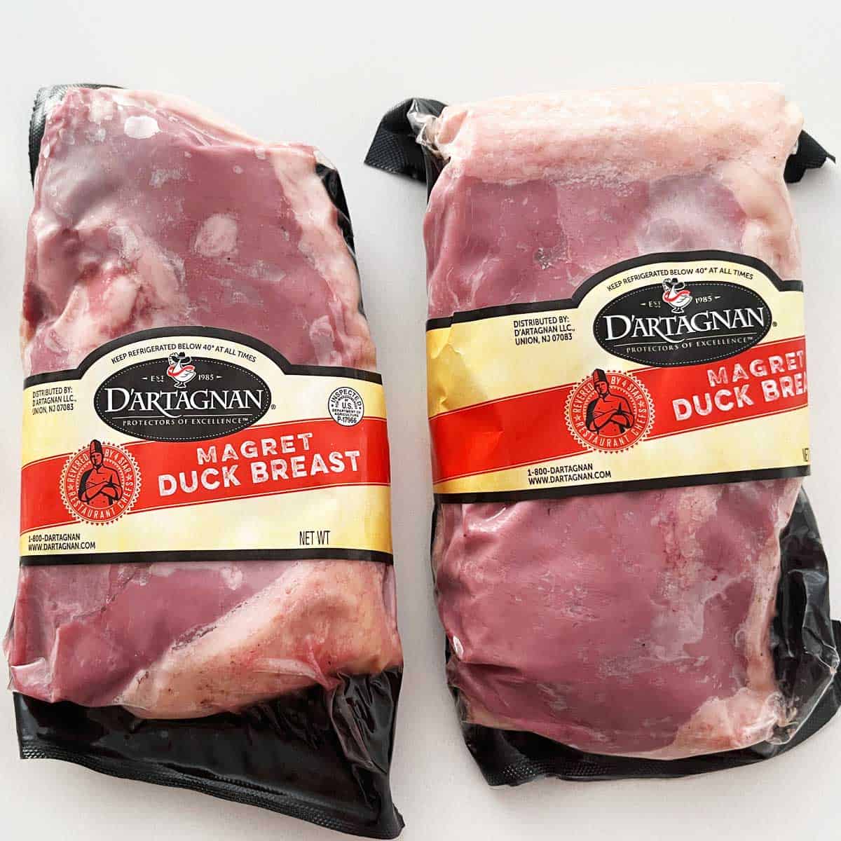 Two packaged duck breasts. 